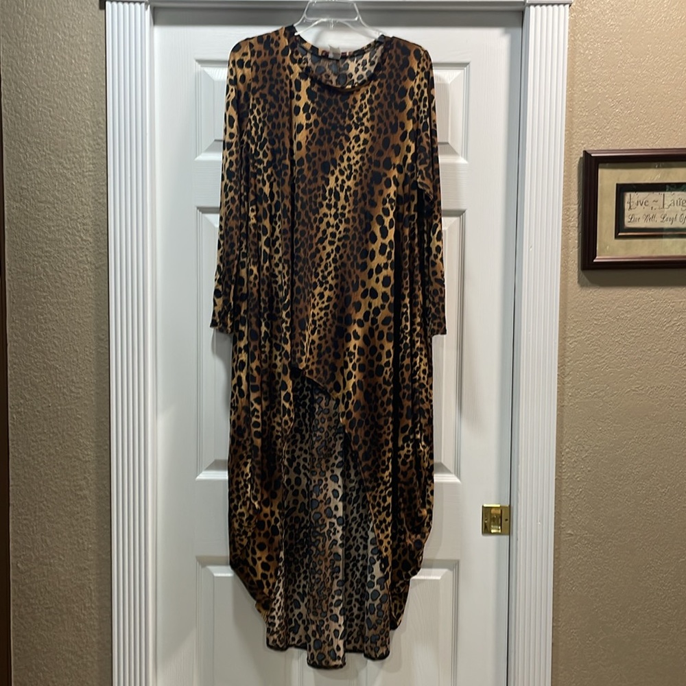 Long sleeve leopard print shirt; short in the front and long in the back.